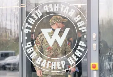  ?? ?? HARD TARGET: A man wearing a camouflage uniform walks out of PMC Wagner Centre in Saint Petersburg, Russia, during its official opening on Nov 4, 2022.