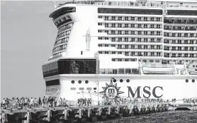  ?? Jose Castillo / AFP via Getty Images ?? The MSC Meraviglia cruise ship, which was turned away by Jamaica and the Cayman Islands after a crew member became sick, docks in Cozumel, Mexico.