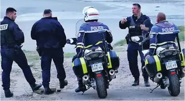  ?? ?? Beach patrol: French police on motorbikes search for migrants planning to cross