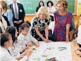  ?? SUSAN WALSH/GETTY-AFP ?? First lady Jill Biden, center, and Romanian first lady Carmen Iohannis visit the Scoala Gimnaziala Uruguay, or Uruguay School, on Saturday in Bucharest, Romania.