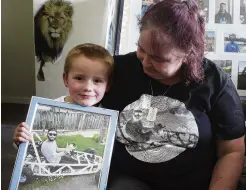  ?? PHOTO: BEN TOMSETT ?? Rememberin­g . . . Sharon Smith would drive her late son Ethan from Gore to Dunedin and back every day for weeks at a time for his leukaemia treatment. Her grandson Kaydin Smith (6) holds a photo of his uncle.