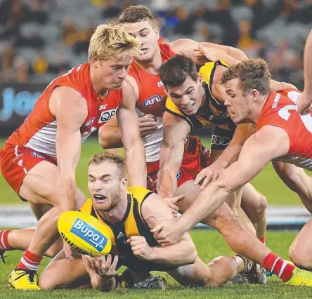  ?? Picture: GETTY IMAGES ?? BALL MAGNET: Hawk Tom Mitchell is swamped by former Swans teammates in Round 8.