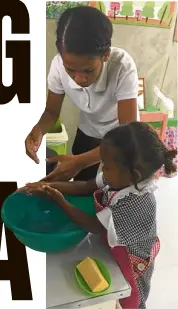  ??  ?? HYGIENE Teacher Vilma Mercado shows her ward how to wash her hands.