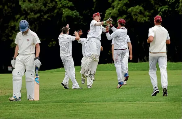  ?? PHOTO MONIQUE FORD / FAIRFAX NZ ?? Upper Hutt players on a celebratio­n high after taking another wicket in Pearce Cup cricket at Trentham Memorial Park on Saturday.