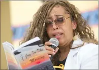  ?? ?? Deborah Smith-gilbert of San Bernardino reads poems from the book “Joy in the Morning” during the Juneteenth festival.