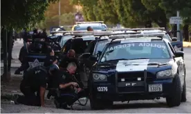  ??  ?? Police take cover during gun battles with cartel forces in Culiacán last week. Photograph: Luis Gerardo Magana