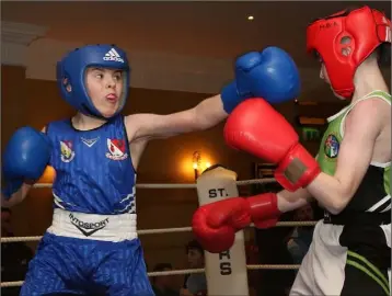  ??  ?? Seán Kearney (St. Aidan’s Boxing Club, blue corner) on the attack against William Ward (Drimnagh B.C.).