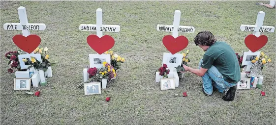  ?? SCOTT OLSON GETTY IMAGES ?? James Otto, a 2011 graduate of Santa Fe High School, leaves flowers at a memorial in front of the school on Monday in Santa Fe, Texas.