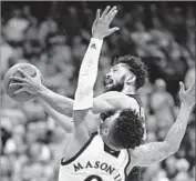  ?? Orlin Wagner Associated Press ?? TCU GUARD Alex Robinson drives against Kansas’ Frank Mason III during the Horned Frogs’ upset.