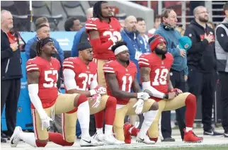  ?? MARCIO JOSE SANCHEZ/AP ?? Several 49ers players kneel during the national anthem before a game in December.