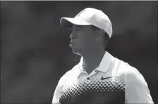  ?? ASSOCIATED PRESS ?? TIGER WOODS WALKS on the third hole during the third round of the Quicken Loans National golf tournament Saturday in Potomac, Md.