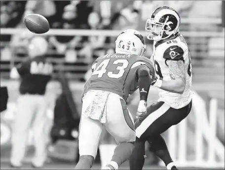  ?? Wally Skalij Los Angeles Times ?? RAMS TIGHT END Tyler Higbee catches a touchdown pass in front of Cardinals linebacker Haason Reddick in the second quarter.