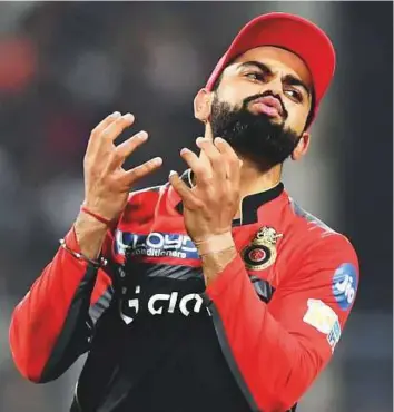  ?? AFP ?? Royal Challenger­s captain Virat Kohli reacts during the Indian Premier League match against Kolkata Knight Riders at The Eden Gardens on Sunday. Kolkata won by 82 runs.