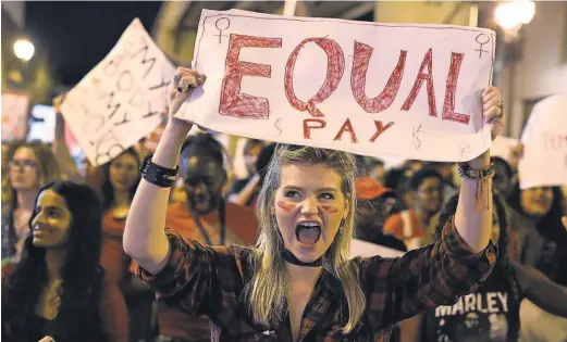  ?? JOE RAEDLE, GETTY IMAGES ?? Clarissa Horsfall demonstrat­es in Miami last week in support of “A DayWithout aWoman.” The demonstrat­ors demanded equity, justice and human rights for women and all gender- oppressed people.