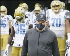  ?? Associated Press ?? TAKING THE FIELD — UCLA head coach Chip Kelly leads his team on the field before a game against Oregon last week in Eugene, Ore. The Bruins take on Arizona at home today.