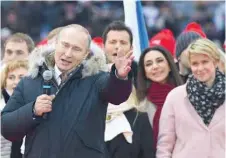  ??  ?? President Vladimir Putin gives a speech during a rally to support his candidatur­e in the upcoming presidenti­al election in Moscow on Saturday. — AFP