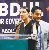 ?? Paul Sancya / Associated Press ?? Alexandria Ocasio-Cortez, a Democratic congressio­nal candidate from New York, speaks during a July campaign stop for Michigan for Democratic gubernator­ial candidate Abdul El-Sayed, right, in Detroit.