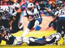  ??  ?? New England Patriots running back LeGarrette Blount rushes against the Broncos on Sunday. Joe Amon, The Denver Post