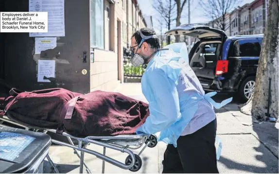  ??  ?? Employees deliver a body at Daniel J. Schaefer Funeral Home, Brooklyn, New York City