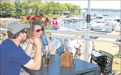  ?? JIM DAY/THE GUARDIAN ?? Al and Heather Bell of Peterborou­gh, Ont., enjoy the scenic view of the Charlottet­own harbour from the deck at Peakes Quay Restaurant and Bar.