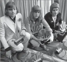  ?? ASSOCIATED PRESS FILE PHOTO ?? Greg Lake, left, Keith Emerson, centre, and Carl Palmer of rock band Emerson, Lake and Palmer, in London in 1972 after an award ceremony. Lake, who founded the group and also launched King Crimson, died Wednesday at age 69 of cancer.