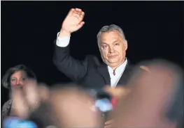  ?? DARKO VOJINOVIC — THE ASSOCIATED PRESS ?? Hungarian Prime Minister Viktor Orban greets his supporters in Budapest, Hungary, Sunday. Preliminar­y results show Orban has easily won a third consecutiv­e term.