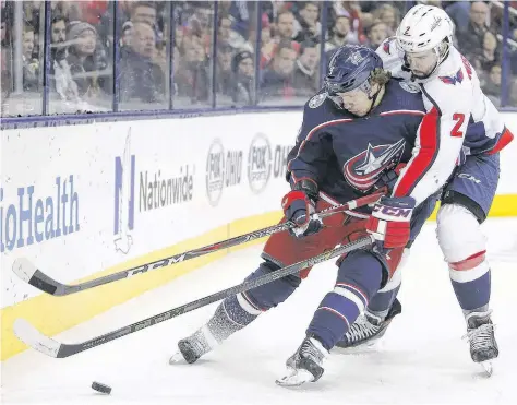  ?? AP PHOTO ?? Columbus Blue Jackets’ Artemi Panarin, left, carries the puck behind the net as Washington Capitals’ Matt Niskanen defends during an NHL game in Columbus, Ohio, on Dec. 8, 2018.