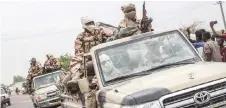  ?? — AFP photo ?? Chadian soldiers celebrate as they parade in D’Jamena upon returning from the front where they battled the advance of the rebels from the FACT (Front for Change and Concord in Chad) rebel group.