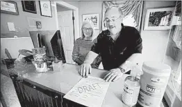  ?? ROBERT F. BUKATY/AP ?? Cod Cove Inn owners Ted and Jill Hugger show a form June 10 in Edgecomb, Maine, that inn owners may be required to have out-of-state guests sign before checking in.