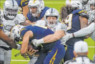  ?? Heidi Fang Las Vegas Review-journal @Heidi Fang ?? Defensive end Maxx Crosby sacks Chargers quarterbac­k Justin Herbert in a key moment. The Raiders defense made plays when they needed them on Sunday and they got a big win in the AFC West.