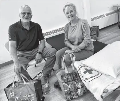  ?? TINA COMEAU ■ SALTWIRE ?? Alison Gledhill and John Grime, evacuees from the Shelburne County wildfire, were very grateful to have landed at a comfort centre in Yarmouth on Wednesday.