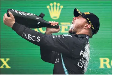  ?? GETTY IMAGES ?? Triumphant: Race winner Valtteri Bottas of Finland and Mercedes GP celebrates on the podium after winning the F1 Grand Prix of Turkey at Intercity Istanbul Park.