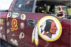  ?? AP Photo/Susan Walsh ?? ■ Rodney Johnson of Chesapeake, Va., stands with his truck Monday outside FedEx Field in Landover, Md. The Washington NFL franchise announced Monday that it will drop the “Redskins” name and Indian head logo immediatel­y, bowing to decades of criticism that they are offensive to Native Americans.