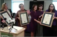  ??  ?? The Unity House is presented with state proclamati­ons for its work in supporting victims of domestic violence.