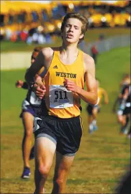  ?? Christian Abraham / Hearst Connecticu­t Media ?? Weston’s Cooper Capola crosses the finish line in Class MM on Saturday at Wickham Park in Manchester.