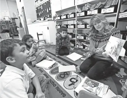  ?? DAN POWERS / USA TODAY NETWORK-WISCONSIN ?? Literacy resource teacher Tiffany Megale leads first grade students Malachi Fernandez, left, Leina Ramirez-Almanza and Oscar Alvarado Vera, right, in a small group word study session Wednesday, December 21, at Banta Bilingual Elementary School in Menasha, Wis.