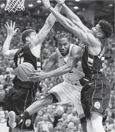  ?? Gregory Shamus / Getty Images ?? Kawhi Leonard scored a game-high 27 points with 17 rebounds and seven assists to lead Toronto over Milwaukee on Saturday night as the Raptors took Game 6 and a 4-2 series win.