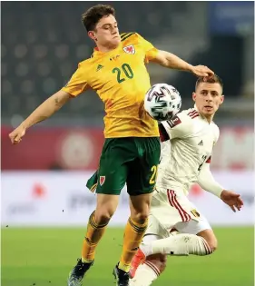  ??  ?? Daniel James is challenged by Thorgan Hazard.