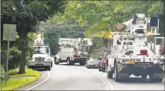  ?? Matthew Brown / Hearst Connecticu­t Media ?? Utility crews make their way along Round Hill Road in Greenwich on Saturday.