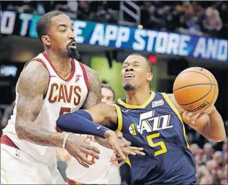  ?? [TONY DEJAK/THE ASSOCIATED PRESS] ?? J.R. Smith of the Cavaliers knocks the ball loose from Rodney Hood of the Jazz in the first half.