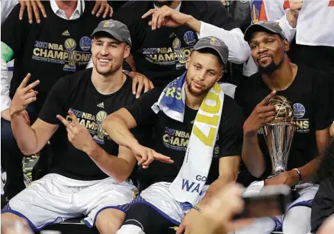  ?? Marcio Sanchez / Associated Press ?? Stephen Curry, center, and Klay Thompson, left, were drafted by the Warriors, with Kevin Durant’s freeagent signing completing this year’s championsh­ip core.