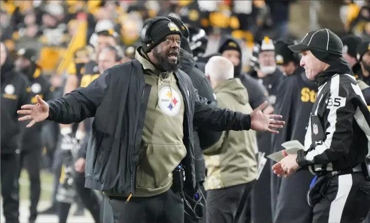  ?? Associated Press ?? Steelers head coach Mike Tomlin talks to an official during the first half Sunday against the Cincinnati Bengals at Acrisure Stadium.