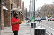  ?? CORNELIUS FROLIK / STAFF ?? A man exits a business on Brown Street near the University of Dayton. Multiple businesses along Brown Street were approved for Paycheck Protection Program loans, including a yoga studio, smoothie shop, Chinese restaurant and a bar.