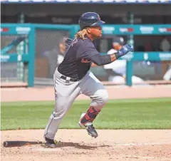  ?? RICK OSENTOSKI/USA TODAY SPORTS ?? Indians third baseman Jose Ramirez (11) run to first base after he hits a single in the eighth inning against the Tigers on Saturday in Detroit.