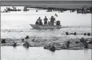  ?? AP/The Virginian-Pilot/ALLISON HESS ?? Chincoteag­ue ponies go ashore Wednesday during the ponies’ 92nd annual swim in Chincoteag­ue, Va., making it across the Assateague channel in four minutes.