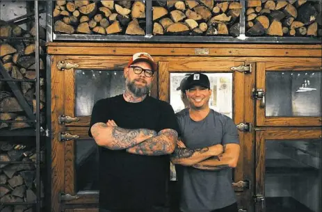  ?? Gracey Evans/Post-Gazette photos ?? Keith Fuller, left, and Richard DeShantz in their new restaurant Pork and Beans on Sixth Street, Downtown.