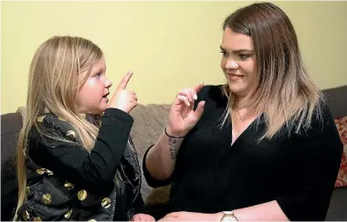  ?? PHOTO: MURRAY WILSON/FAIRFAX NZ ?? Mila Bardell, 5, teaches her mother, Chelsea Bardell, sign language after learning it on YouTube Kids.