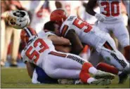  ?? KELVIN KUO — THE ASSOCIATED PRESS ?? Chargers tight end Hunter Henry is tackled by Browns linebacker Deon King, top, and middle linebacker Joe Schobert during the second half on Dec. 3 in Carson, Calif.