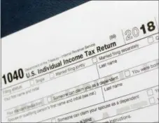  ?? MARK LENNIHAN — THE ASSOCIATED PRESS ?? A portion of the 1040 U.S. Individual Income Tax Return form for 2018 is displayed, Tuesday, July 24, 2018, in New York. The $1.5-trillion tax overhaul includes the end of a 75-year-old deduction on alimony payments.