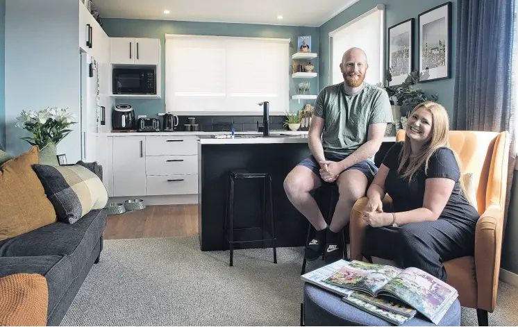  ?? PHOTO: GERARD O’BRIEN ?? Their home is their castle . . . Interior designer Rachel Covey and her fiance Josh Nicholls relax in the living area of their extensivel­y renovated Green Island home.